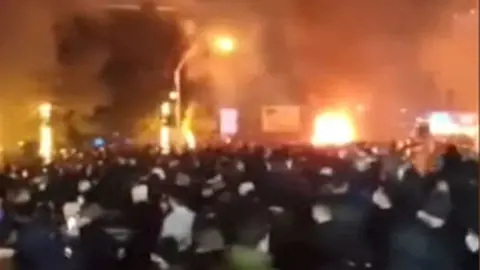 A large fire, which appears to be burning in a city street of Iran.