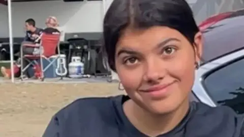 COURTESY FACEBOOK/TODD JAMES The 19 year old is smiling at a camera outdoors. Her dark hair is tied up and she is wearing a dark coloured jumper. 