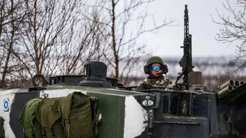Getty Images A Finnish soldier of the Finnish-Swedish Division rides the Leopard 2A6 battle tank, during a demonstration of border crossing by Swedish and Finnish troops as part of the NATO Nordic Response 24 military exercise 