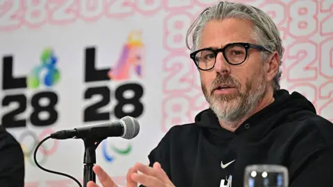Getty Images Casey Wasserman speaks during a press conference at the LA Convention Center in Los Angeles on June 5, 2025.